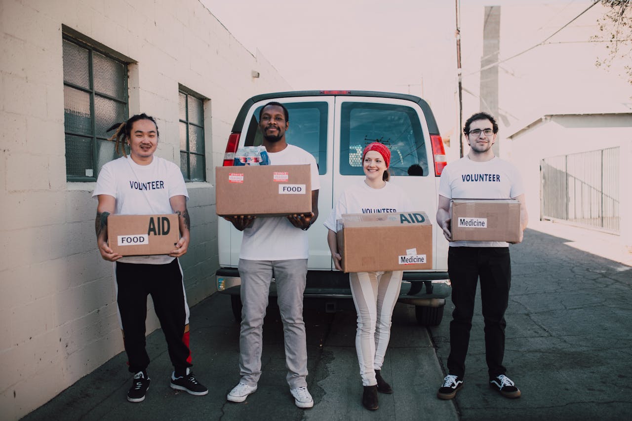 The Art of Drawing Readers In: Your attractive post title goes here Group of volunteers holding aid boxes, ready to distribute in the community.