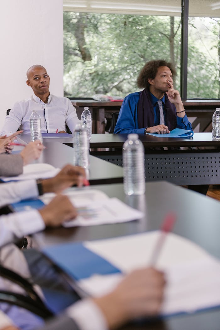 hero A diverse group of professionals attentively participating in a formal business meeting.